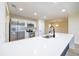 Kitchen island with sink and modern faucet, stainless steel appliances and white cabinets at 2931 Chilton St, Deltona, FL 32738