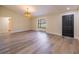 Bright living room with wood-look flooring, a stylish pendant light, and a large window offers an inviting space at 2931 Chilton St, Deltona, FL 32738