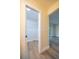 Walk-in closet with white shelving and wood-look floors at 2931 Chilton St, Deltona, FL 32738