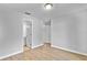 Bright bedroom featuring wood-look floors, neutral paint, and an ensuite bathroom at 30 Las Palmas Way, Kissimmee, FL 34743