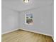 Neutral bedroom featuring wood-look floors and a window at 30 Las Palmas Way, Kissimmee, FL 34743