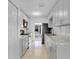 Galley kitchen features modern appliances, stone countertops, and bright white cabinetry at 30 Las Palmas Way, Kissimmee, FL 34743