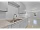 Updated kitchen with white cabinets, stone countertops, and open layout at 30 Las Palmas Way, Kissimmee, FL 34743