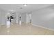 Spacious living room with tile flooring and seamless transition to kitchen at 30 Las Palmas Way, Kissimmee, FL 34743
