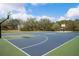 Well-maintained community basketball court with greenery, benches, and picnic tables in background at 3304 Cat Brier Trl, St Cloud, FL 34773