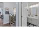 Well-lit bathroom with gray vanity and a decorative mirror at 3304 Cat Brier Trl, Harmony, FL 34773