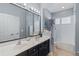 Bathroom featuring a double vanity, a large mirror, ample lighting, and a shower-tub combination at 3304 Cat Brier Trl, Harmony, FL 34773