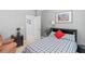 Bedroom with a cozy recliner and a bed featuring a blue plaid bedspread, offering a comfortable and inviting space at 3304 Cat Brier Trl, Harmony, FL 34773