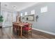 Elegant dining room with a large wooden table, decorative mirror, and ample seating for Gathering gatherings at 3304 Cat Brier Trl, Harmony, FL 34773