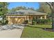 Charming single-story home with well-manicured lawn, mature trees, and attached two-car garage at 3304 Cat Brier Trl, Harmony, FL 34773