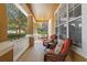 Inviting front porch featuring comfortable seating, decorative pillows, and a view of the surrounding neighborhood at 3304 Cat Brier Trl, Harmony, FL 34773