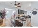 Stylish kitchen area featuring a dining table, modern lighting, and views of the adjoining living spaces at 3304 Cat Brier Trl, Harmony, FL 34773