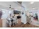 Open-concept kitchen with black cabinetry, modern appliances, and a view of the dining area and living room at 3304 Cat Brier Trl, Harmony, FL 34773