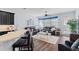 Open living room with modern lighting, dark leather sofas, and breakfast bar at 3304 Cat Brier Trl, Harmony, FL 34773