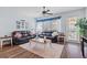 Bright living room with plenty of natural light, ceiling fan, and comfortable seating at 3304 Cat Brier Trl, Harmony, FL 34773