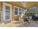 Covered patio area featuring neutral color scheme, grill, table, chairs, and decorative accents at 3304 Cat Brier Trl, Harmony, FL 34773