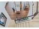 Bright staircase featuring neutral carpeting and a contrasting dark wood and white railing leading to the home's second floor at 3304 Cat Brier Trl, Harmony, FL 34773