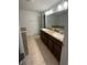 This bathroom has double sinks with dark wood cabinets and neutral countertops at 3555 Rodrick Cir, Orlando, FL 32824