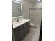 Updated bathroom boasts a modern vanity, lighted mirror, and separate tiled shower stall at 3555 Rodrick Cir, Orlando, FL 32824