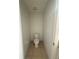 This half bathroom is neutral colored with tile flooring and updated toilet at 3555 Rodrick Cir, Orlando, FL 32824