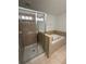 This bathroom features a shower with glass doors, and a soaking tub at 3555 Rodrick Cir, Orlando, FL 32824