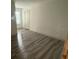 This bedroom has hardwood floors, a window, and a white door at 3555 Rodrick Cir, Orlando, FL 32824