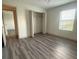 Bright bedroom features wood-look floors, walk-in closet, and a window at 3555 Rodrick Cir, Orlando, FL 32824