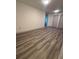 Bright bedroom features wood-look flooring, with two doors and modern ceiling lights at 3555 Rodrick Cir, Orlando, FL 32824