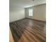 Bright bedroom offers wood-look flooring and a window allowing natural light at 3555 Rodrick Cir, Orlando, FL 32824