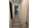Bright hallway features wood-look flooring, neutral wall paint, and modern lighting at 3555 Rodrick Cir, Orlando, FL 32824