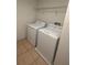 This laundry room has tile floors, wire shelving, and a washer and dryer at 3555 Rodrick Cir, Orlando, FL 32824