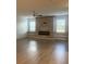 Modern living room featuring hardwood floors, updated fireplace and lots of natural light at 3555 Rodrick Cir, Orlando, FL 32824