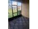 Covered patio area with checkered flooring and views of the backyard and neighborhood at 3555 Rodrick Cir, Orlando, FL 32824
