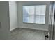 Bright bedroom with modern grey flooring and a window with light-filtering blinds at 3655 Zuma Way, Orlando, FL 32839