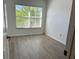 Bright bedroom featuring neutral walls, natural light, and wood-look flooring at 3655 Zuma Way, Orlando, FL 32839