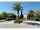 View of gated community entrance surrounded by palm trees and manicured landscaping at 3655 Zuma Way, Orlando, FL 32839