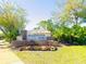 Beautiful monument sign at Millennium Parc surrounded by flowers, trees, and lush landscaping at 3655 Zuma Way, Orlando, FL 32839