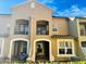 Charming multi-story townhouse with private balconies and well-maintained landscaping against a bright sky at 3655 Zuma Way, Orlando, FL 32839