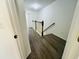 Upstairs hallway with vinyl flooring, wood banister, and neutral colors, offering a bright aesthetic at 3655 Zuma Way, Orlando, FL 32839