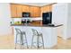 Eat-in kitchen featuring wood cabinets, granite countertops, and stainless steel appliances at 3655 Zuma Way, Orlando, FL 32839