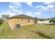 The backyard features a lawn and the house's tan stucco exterior at 3705 Apopka Ridge Cir, Apopka, FL 32703
