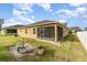 The backyard features a green lawn and a screened in patio area at 3705 Apopka Ridge Cir, Apopka, FL 32703