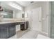 Bathroom features a double sink vanity, tile floors, and a glass door shower with great natural lighting at 3705 Apopka Ridge Cir, Apopka, FL 32703