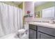 Bathroom features a shower with curtain and sink with dark cabinets and colorful decor at 3705 Apopka Ridge Cir, Apopka, FL 32703