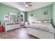 Charming bedroom features a ceiling fan, hardwood floors, and a dresser at 3705 Apopka Ridge Cir, Apopka, FL 32703