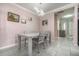 A modern dining room with a gray table and chairs is illuminated by a unique light fixture at 3705 Apopka Ridge Cir, Apopka, FL 32703