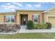 A well landscaped front yard, with maroon shutters and a deep-set door at 3705 Apopka Ridge Cir, Apopka, FL 32703