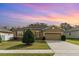 Charming single-story home featuring a manicured lawn, mature shrubbery, and a two-car garage at 3705 Apopka Ridge Cir, Apopka, FL 32703