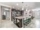 A large kitchen island has seating and overlooks the adjacent breakfast bar at 3705 Apopka Ridge Cir, Apopka, FL 32703
