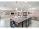 An open kitchen island with sink and dishwasher overlooks the living room at 3705 Apopka Ridge Cir, Apopka, FL 32703